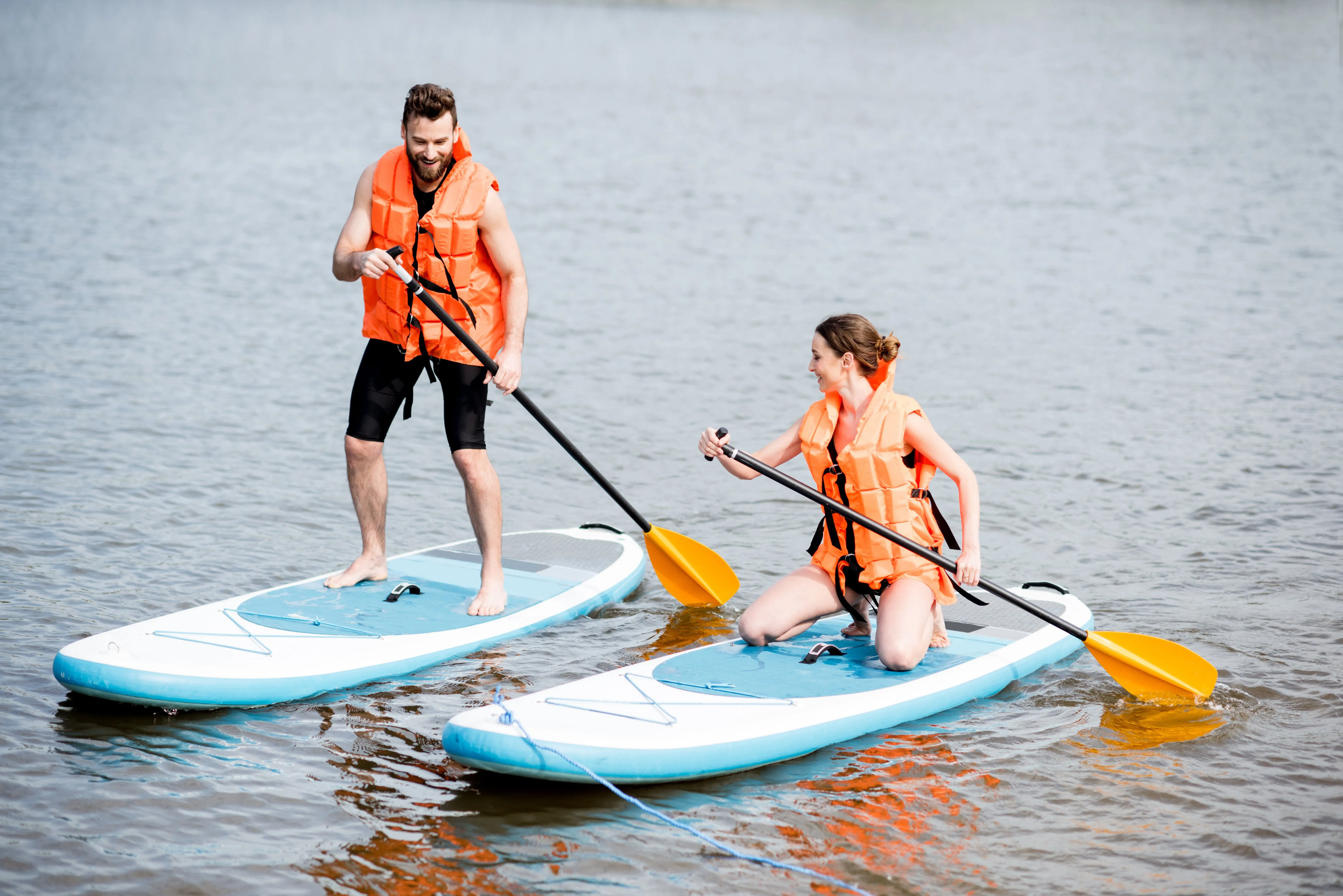 Couple rowing on the stand up paddleboard